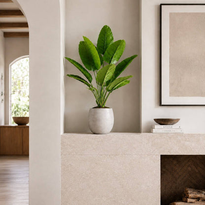 12-leaf artificial travelers palm styled on a wooden sideboard in a modern home