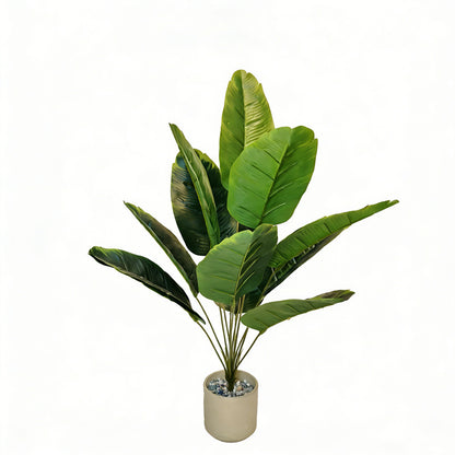 12-leaf artificial travelers palm styled beside a window in a neutral room